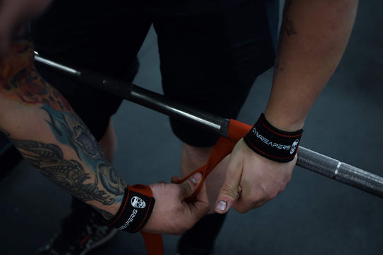 Athlete showcasing the comfort and support of Gymreapers weightlifting wrist straps during a training session.