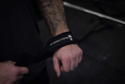 Athlete using Gymreapers weightlifting wrist straps during a powerlifting session, highlighting their effectiveness.