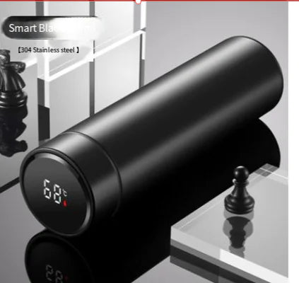 The LED Temperature Display Thermos Bottle beside a smartphone, emphasizing modern technology.