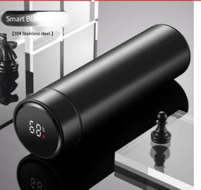 The LED Temperature Display Thermos Bottle beside a smartphone, emphasizing modern technology.